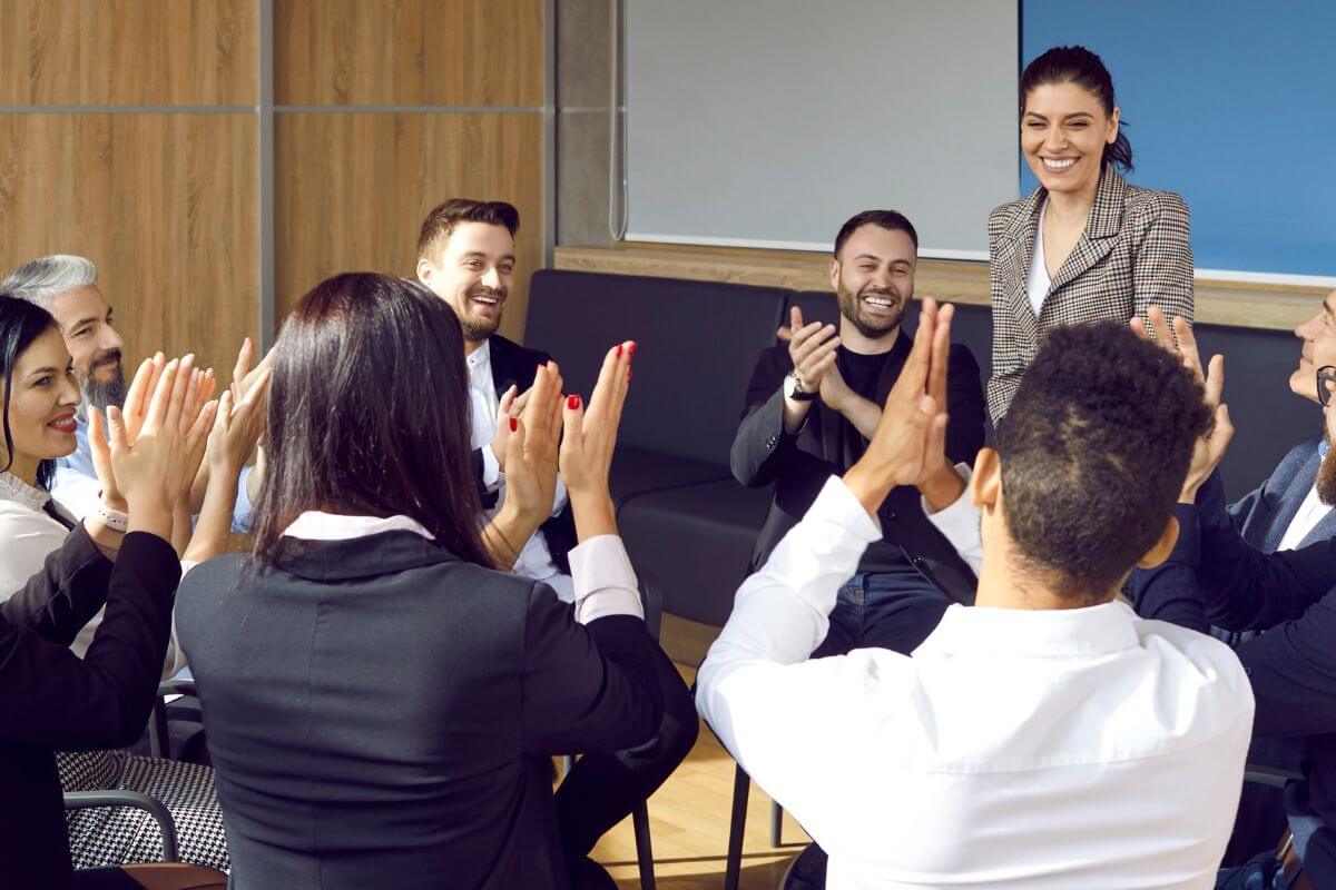 Employees applauding a team member