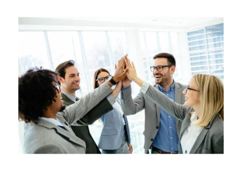 A group of employees is rejoicing, high-fiving one another
