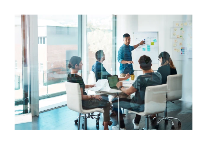 a man leading a formal group meeting and strategic outsourcing