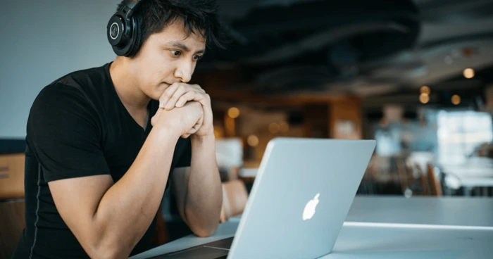 a man looking on his laptop