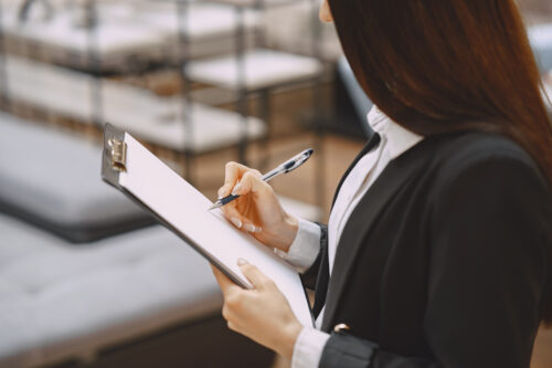Professional woman holding a clipboard checklist