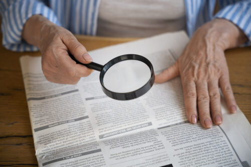 Magnifying glass pointed into documents