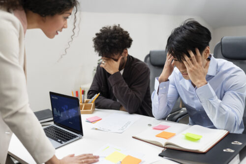 Stressed coworkers in an office meeting