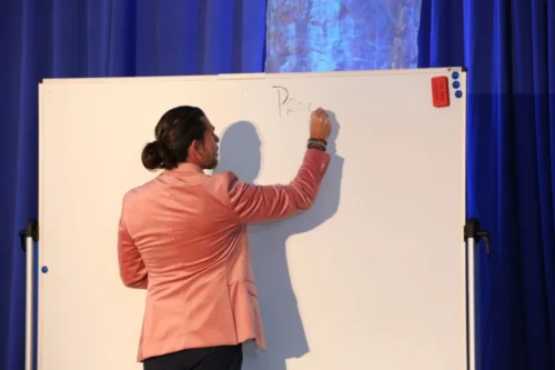 Anthony Rice writing on the whiteboard