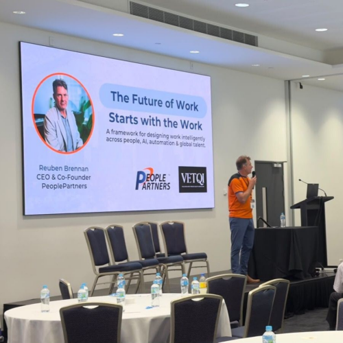 Reuben Brennan on stage giving a presentation